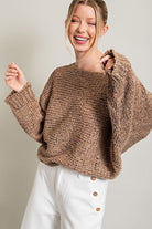 Model wearing neutral knit sweater.  Fall fashion