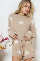 Model wearing a cozy beige lounge set with a star print design. The set includes a relaxed-fit, long-sleeve top with white star accents and matching drawstring shorts, perfect for comfortable and stylish loungewear