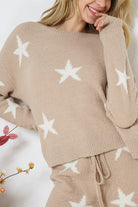 Model wearing a cozy beige lounge set with a star print design. The set includes a relaxed-fit, long-sleeve top with white star accents and matching drawstring shorts, perfect for comfortable and stylish loungewear