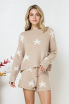 Model wearing a cozy beige lounge set with a star print design. The set includes a relaxed-fit, long-sleeve top with white star accents and matching drawstring shorts, perfect for comfortable and stylish loungewear