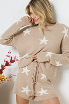 Model wearing a cozy beige lounge set with a star print design. The set includes a relaxed-fit, long-sleeve top with white star accents and matching drawstring shorts, perfect for comfortable and stylish loungewear