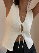 Model wearing white knit tie front vest, sleeveless