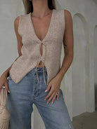 Model wearing tan knit tie front vest, sleeveless