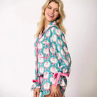 Women's teal holiday pajama set with Santa Claus wreath print, featuring a long-sleeve top and relaxed-fit shorts with festive rose piping, ruffle details velvet bow ties, perfect cozy sleepwear or holiday gift for women. Trendy, cute Christmas loungewear for stylish comfort during holiday movie nights, gift exchanges, or lounging at home.