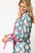 Women's teal holiday pajama set with Santa Claus wreath print, featuring a long-sleeve top and relaxed-fit shorts with festive rose piping, ruffle details velvet bow ties, perfect cozy sleepwear or holiday gift for women. Trendy, cute Christmas loungewear for stylish comfort during holiday movie nights, gift exchanges, or lounging at home.